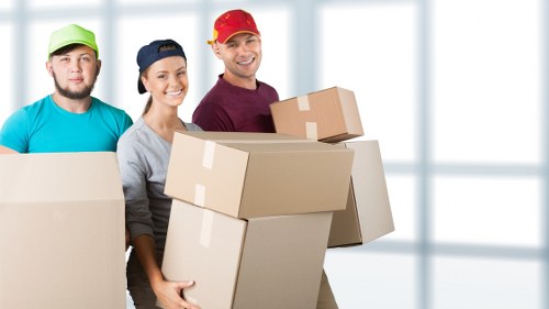 Local movers preparing boxes for a business relocation in London