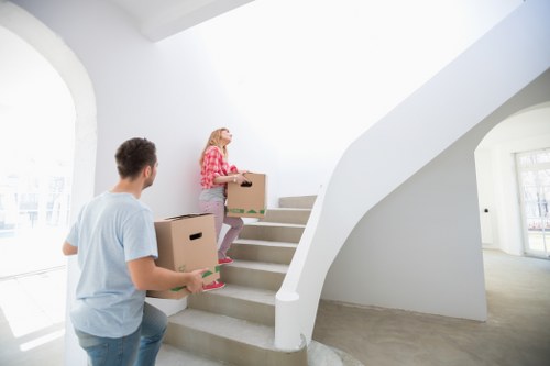 Professional movers handling boxes and furniture during a London relocation